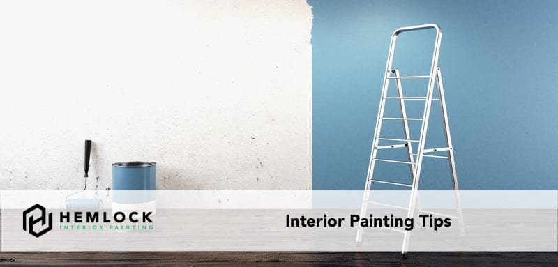 featured image interior painting tips ladder, paint bucket and roller against a partly painted wall