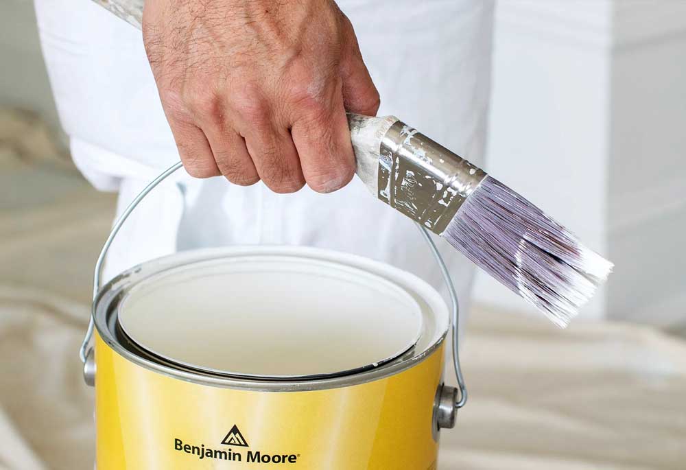 A bucket of high-quality paint from Benjamin Moore that will be used on the exterior of the house.